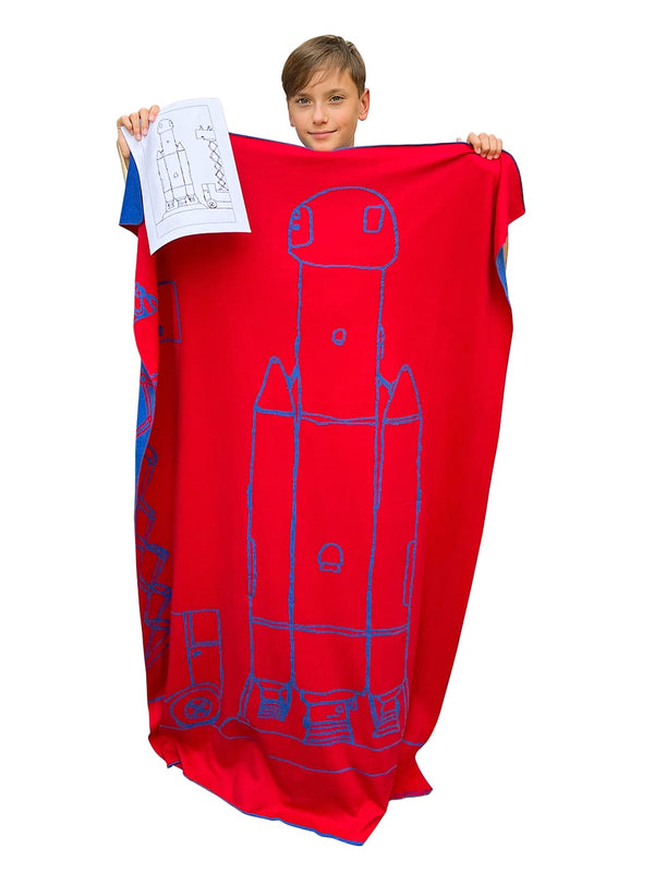 We knit your drawing into a unique cotton blanket. It is one of the most unique nursery accessories. This red and blue children's blanket has a drawing of a rocket.